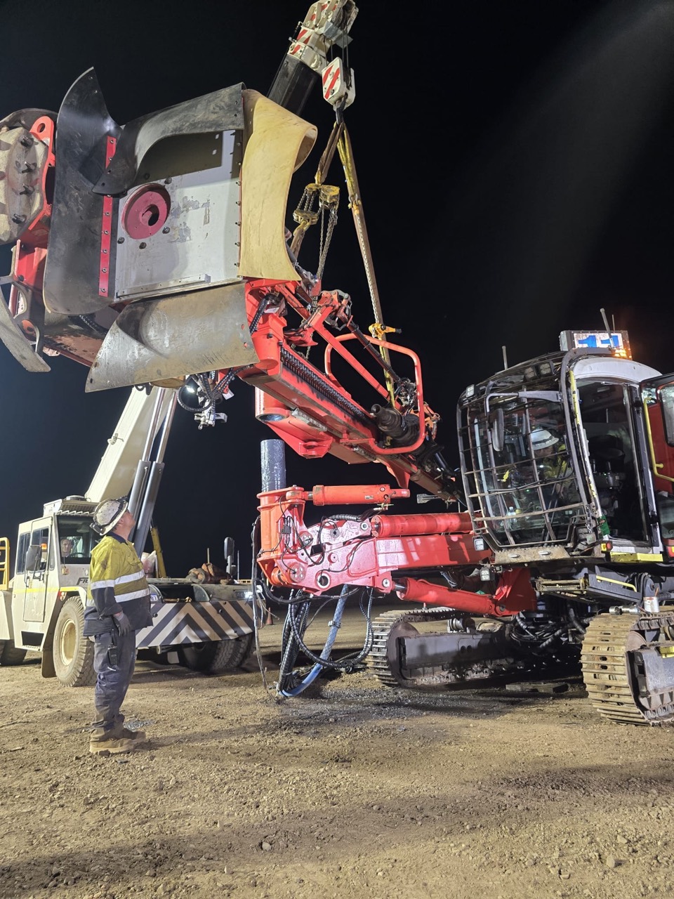 Exploration drill equipment under repair at night
